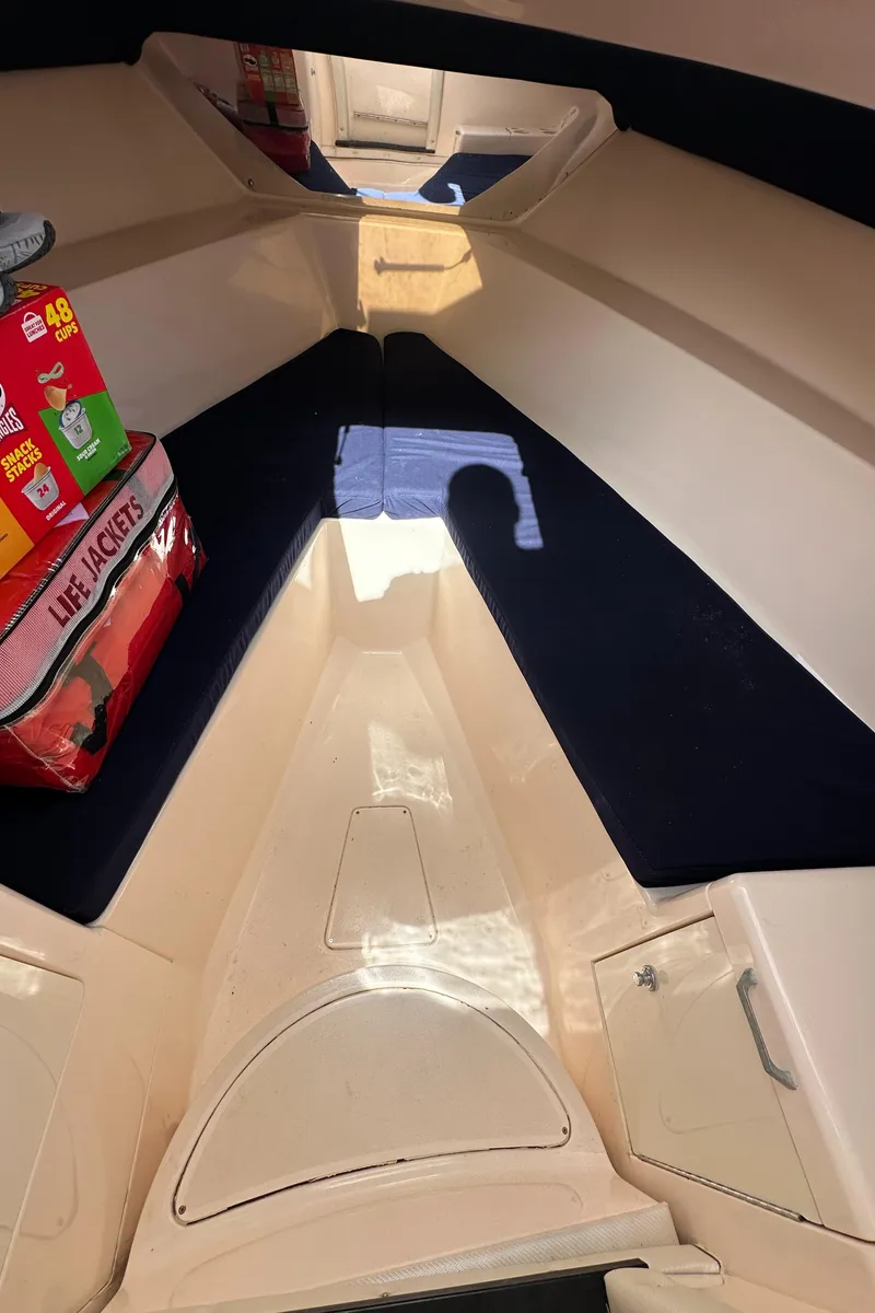 Slide: The Image of Interior of 2005 Intrepid 323 boat with life jackets and supplies. - 19