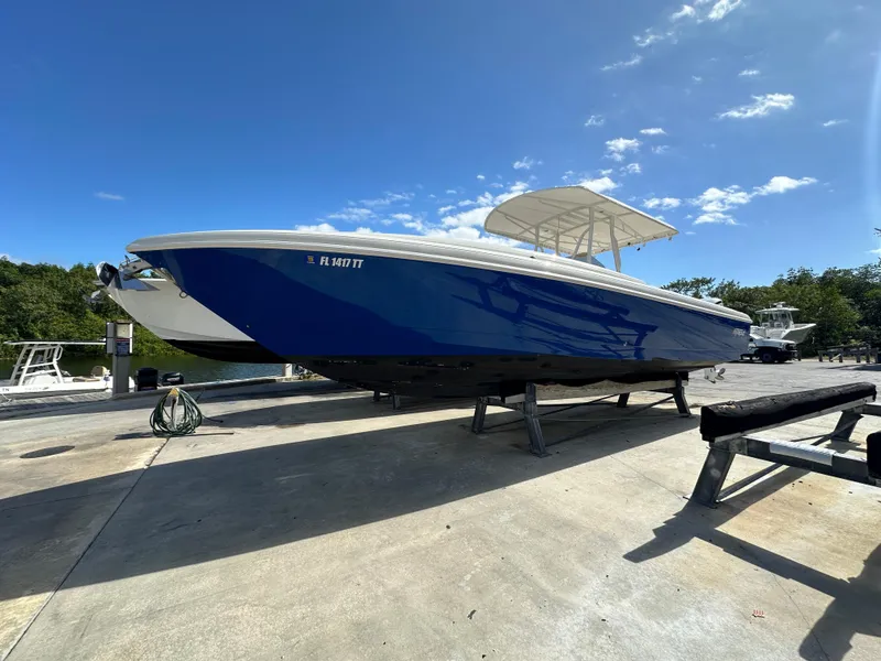 Slide: The Image of 2005 Intrepid 323 boat on trailer under clear blue sky. - 2
