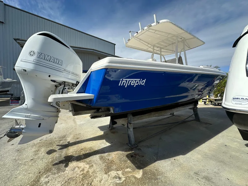 Slide: The Image of Blue 2005 Intrepid 323 boat with Yamaha outboard motor on a trailer. - 24