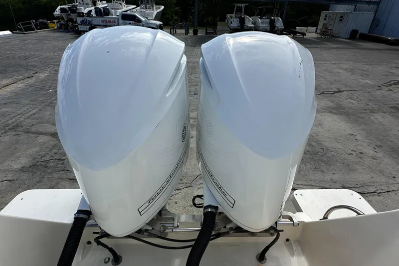 Slide: The Image of Twin outboard motors on a 2005 Intrepid 323 boat, parked on concrete. - 29