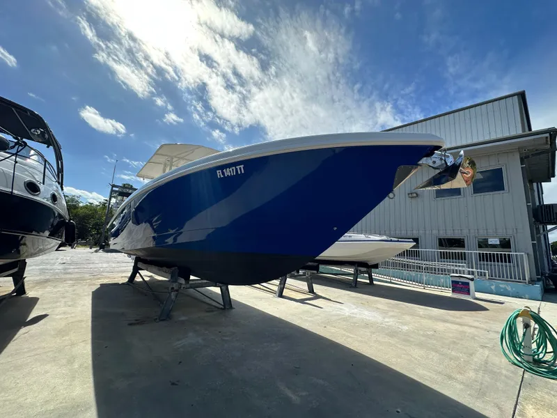 Slide: The Image of 2005 Intrepid 323 boat on display under a clear blue sky. - 3