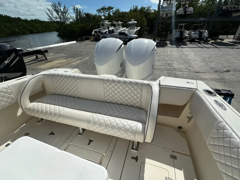 Slide: The Image of 2005 Intrepid 323 boat with white quilted seating and dual outboard motors. - 7