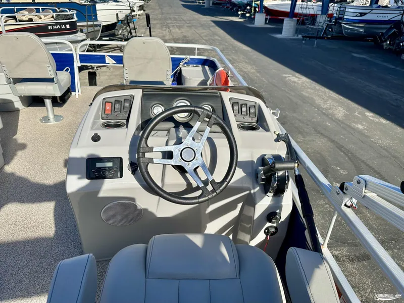 Slide: The Image of 2021 Bennington 20SV boat console with steering wheel and controls. - 11