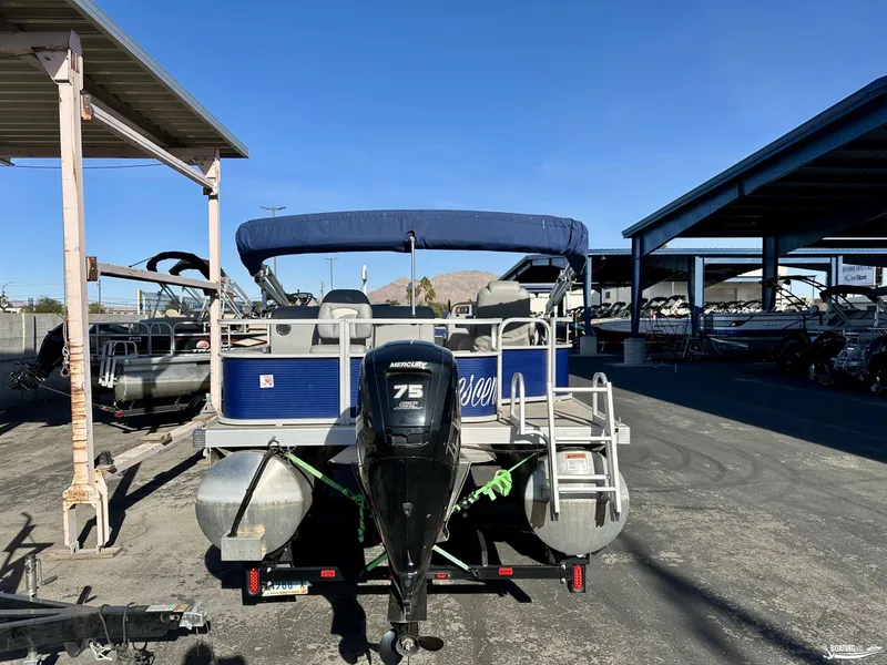 Slide: The Image of 2021 Bennington 20SV pontoon boat with Mercury 75 engine in storage facility. - 4