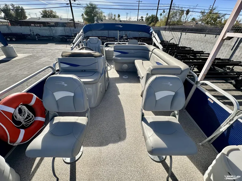 Slide: The Image of 2021 Bennington 20SV pontoon boat interior with gray seating and life preserver. - 5