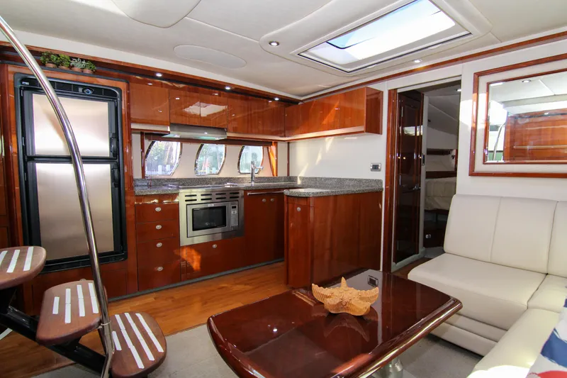 Slide: The Image of Luxurious interior of 2008 Sea Ray 48 Sundancer yacht with modern kitchen and seating area. - 11