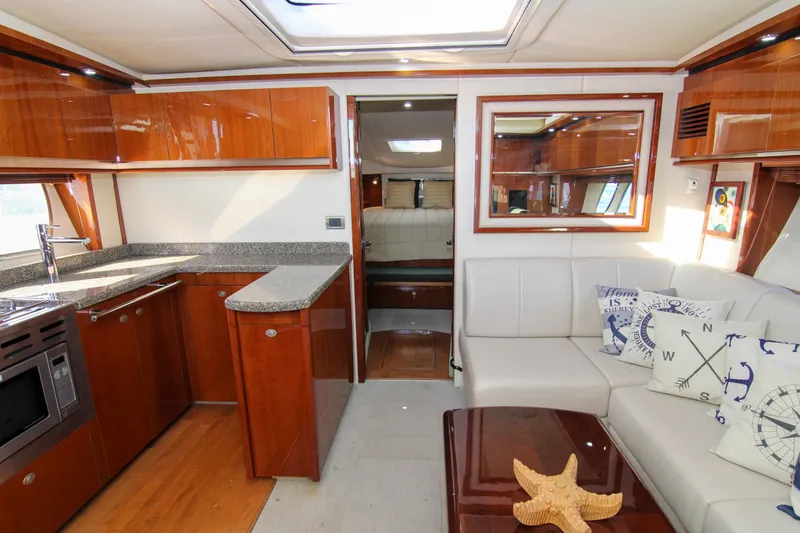 Slide: The Image of Luxurious 2008 Sea Ray 48 Sundancer yacht interior with modern kitchen and cozy seating area. - 14