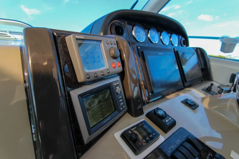 Slide: The Image of 2008 Sea Ray 48 Sundancer helm with navigation instruments and control panels. - 17