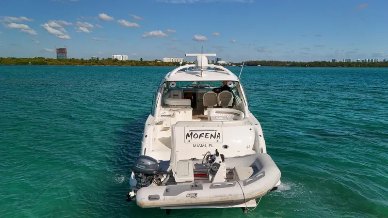 Slide: The Image of 2008 Sea Ray 48 Sundancer yacht on turquoise water, rear view. - 2