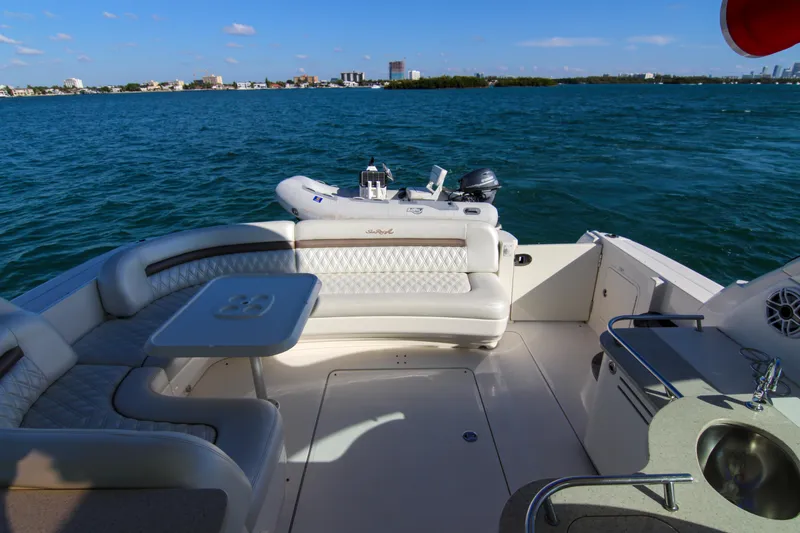 Slide: The Image of 2008 Sea Ray 48 Sundancer yacht with spacious deck and seating, cruising on blue waters. - 22