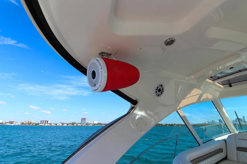 Slide: The Image of 2008 Sea Ray 48 Sundancer yacht interior with speaker, overlooking blue ocean and city skyline. - 26