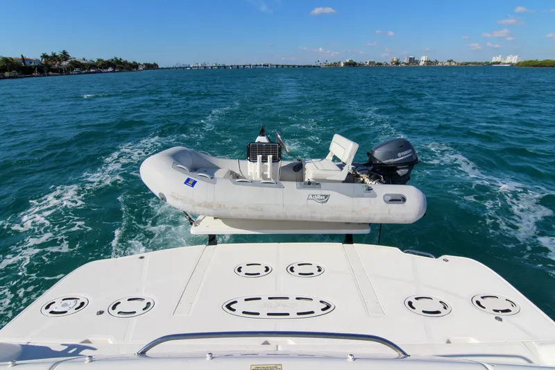 Slide: The Image of 2008 Sea Ray 48 Sundancer with dinghy on blue ocean waters. - 27