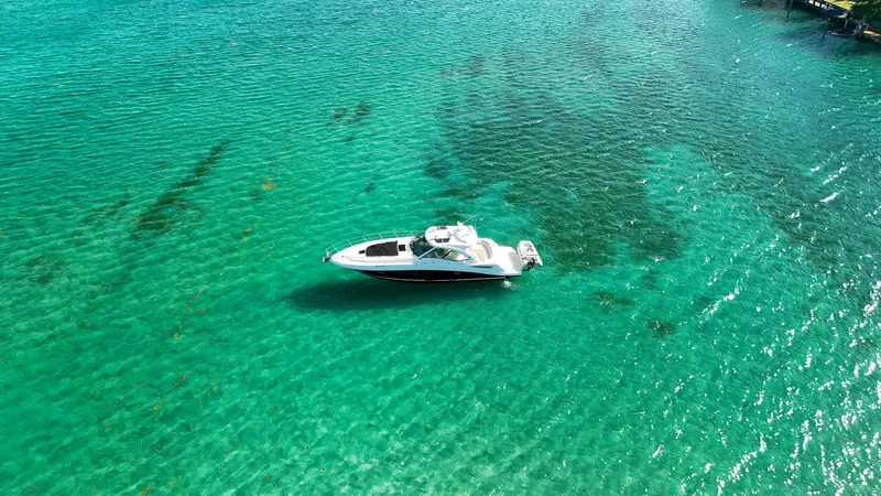 Slide: The Image of 2008 Sea Ray 48 Sundancer yacht on clear turquoise water. - 6