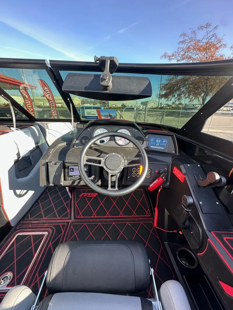 Slide: The Image of 2022 MB Tomcat F22 Alpha boat interior with steering wheel and dashboard controls. - 17