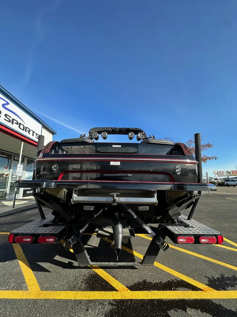 Slide: The Image of 2022 MB Tomcat F22 Alpha boat on trailer, parked outside dealership under clear blue sky. - 7