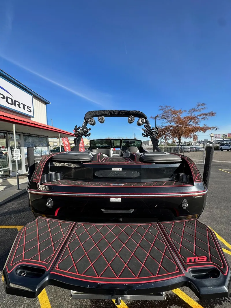 Slide: The Image of 2022 MB Tomcat F22 Alpha boat, rear view, parked outdoors at a dealership. - 8