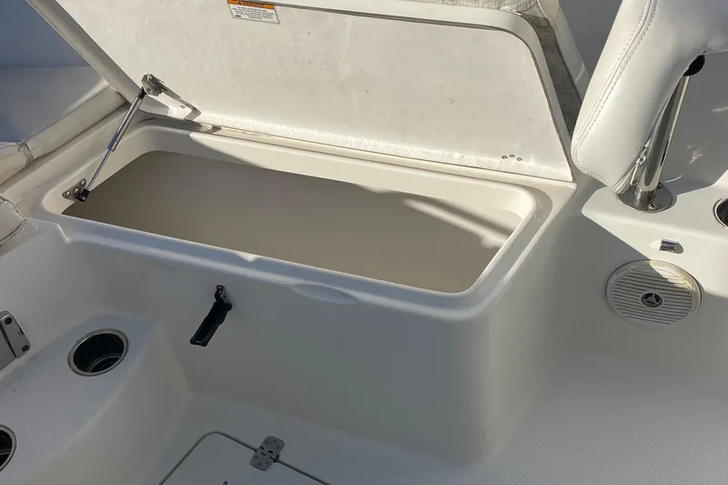 Slide: The Image of Open storage compartment on 2015 Sailfish 240 boat deck. - 10