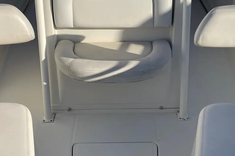 Slide: The Image of Interior seating of 2015 Sailfish 240 boat, featuring white cushioned seats. - 11