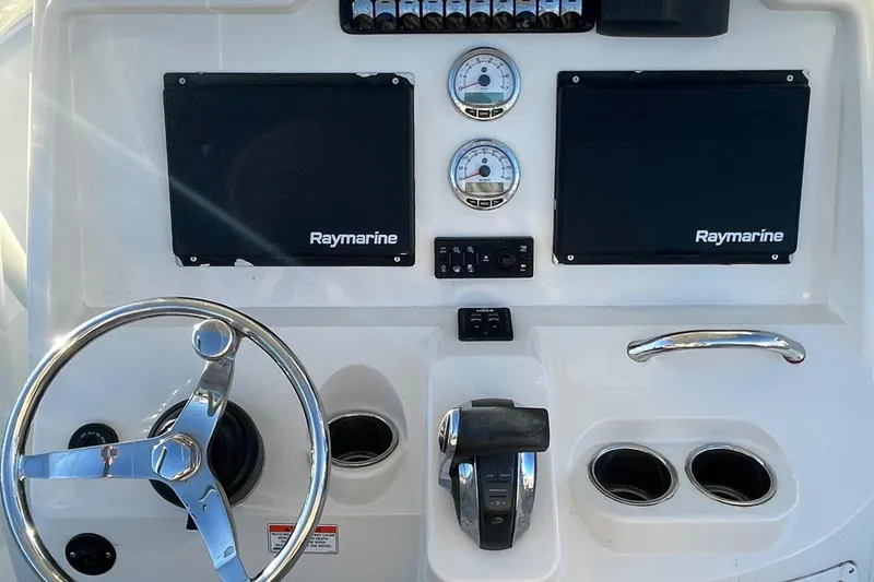 Slide: The Image of Sailfish 240 boat dashboard with Raymarine displays and steering wheel, 2015 model. - 13