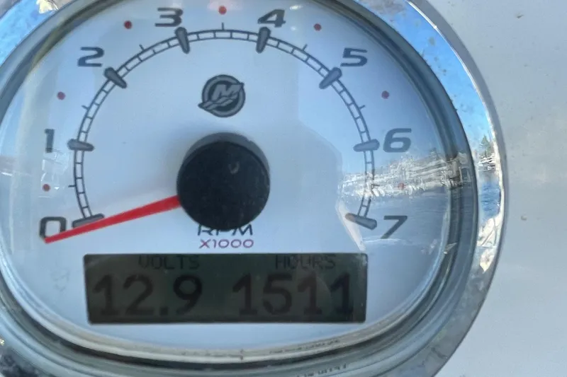 Slide: The Image of Close-up of a Sailfish 240 tachometer showing 12.9 volts and 1511 hours. - 17