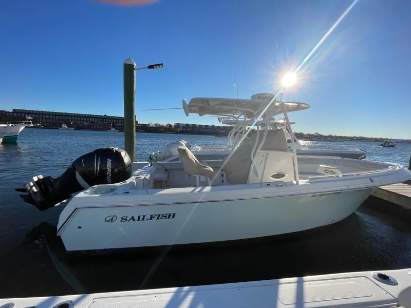 Slide: The Image of 2015 Sailfish 240 boat docked under clear blue sky. - 2