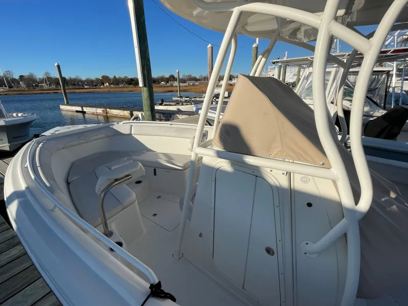 Slide: The Image of 2015 Sailfish 240 boat docked, featuring spacious seating and sleek design. - 5