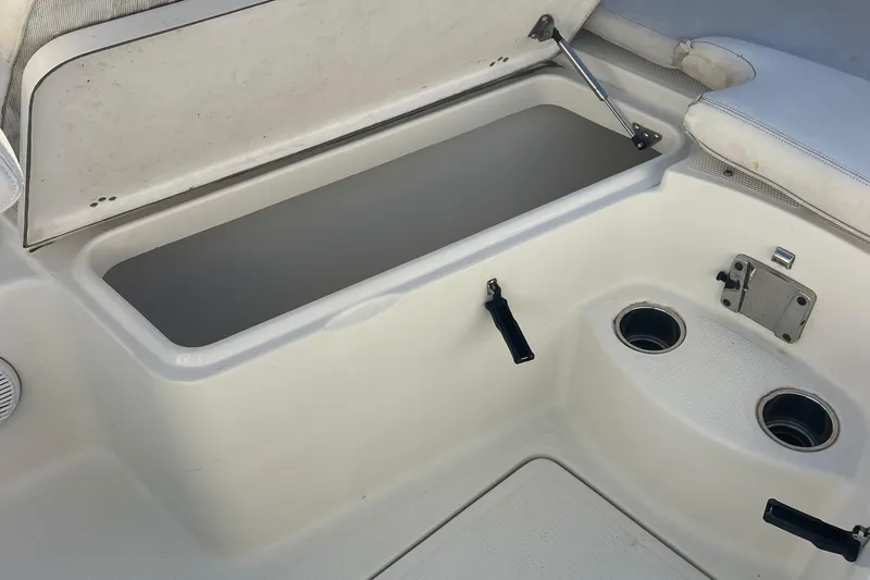 Slide: The Image of Open storage compartment on 2015 Sailfish 240 boat with cup holders. - 9