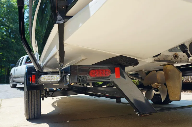 Slide: The Image of 2014 Tigé R20 boat on trailer, showing propeller and rear details. - 11