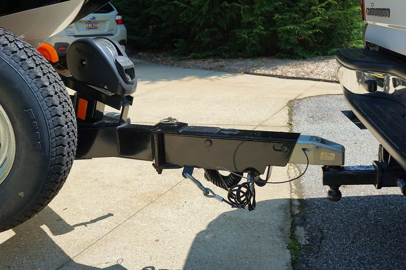 Slide: The Image of 2014 Tigé R20 boat trailer hitch connected to a vehicle in a driveway. - 13