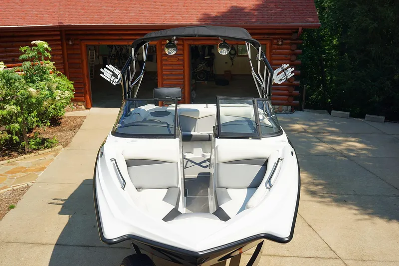Slide: The Image of 2014 Tigé R20 boat with sleek design parked in driveway. - 16