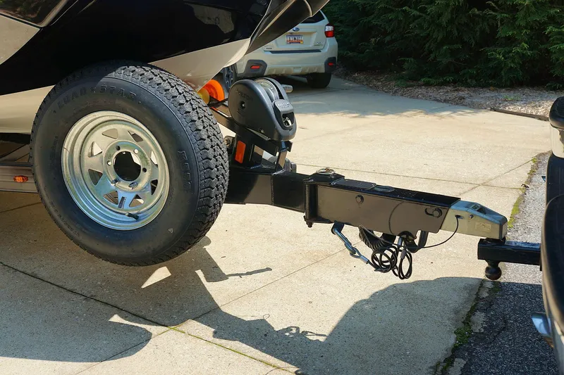 Slide: The Image of 2014 Tigé R20 boat trailer hitch and wheel on driveway. - 23