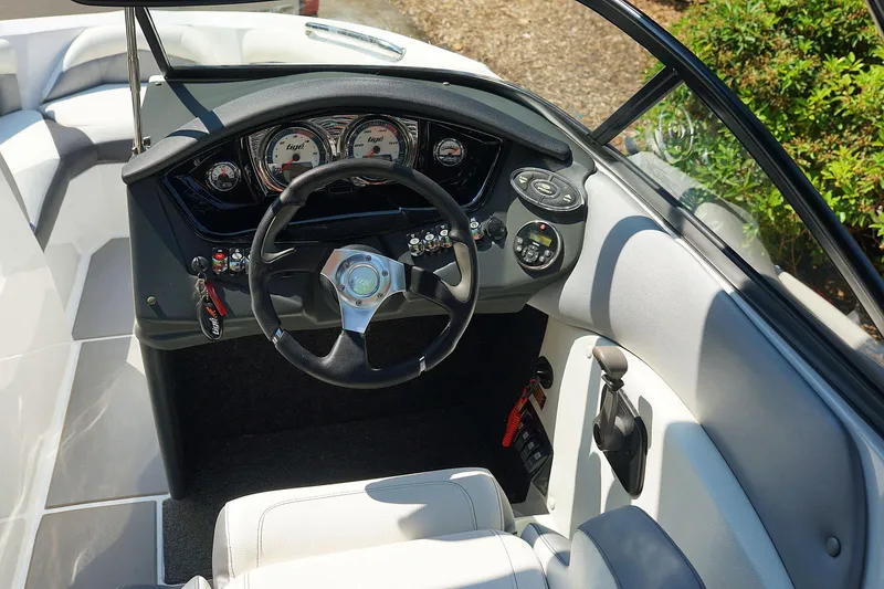 Slide: The Image of 2014 Tigé R20 boat dashboard with steering wheel and gauges. - 24