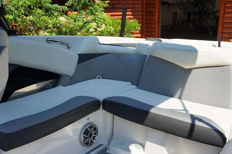 Slide: The Image of 2014 Tigé R20 boat interior with gray and white seating, speaker, and cup holder. - 27