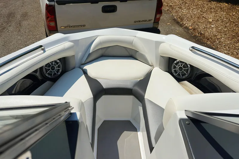 Slide: The Image of 2014 Tigé R20 boat interior with white seating and speakers. - 28