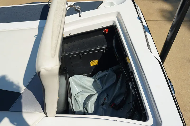 Slide: The Image of Open storage compartment in 2014 Tigé R20 boat, showing battery and wiring. - 40