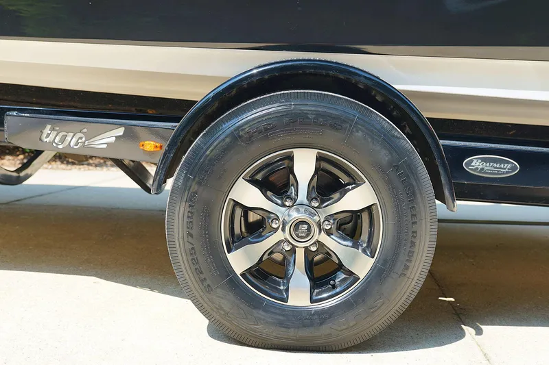 Slide: The Image of 2014 Tigé R20 boat trailer wheel with black and silver rim design. - 41