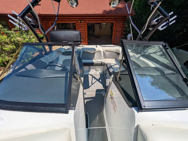 Slide: The Image of 2014 Tigé R20 boat interior with open windshield and seating area. - 46