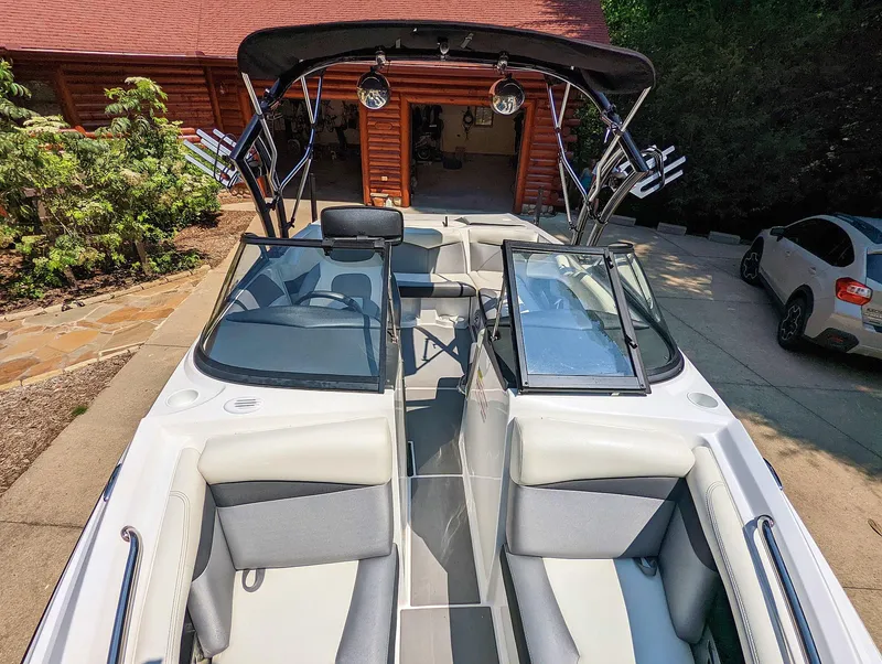 Slide: The Image of 2014 Tigé R20 boat with sleek interior and modern design in driveway setting. - 47