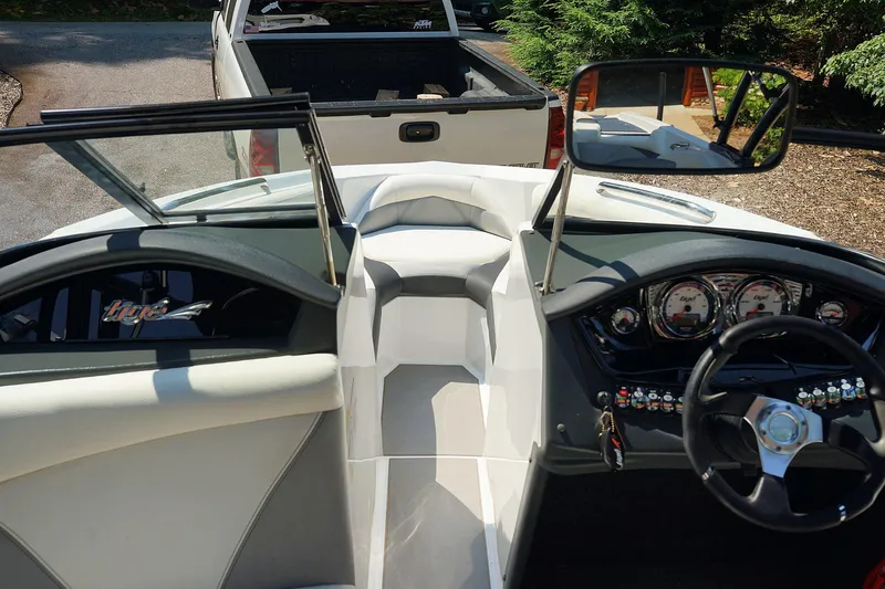 Slide: The Image of 2014 Tigé R20 boat interior with steering wheel and dashboard controls. - 49