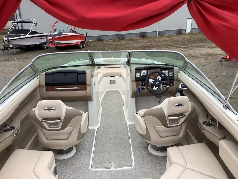 Slide: The Image of 2012 Chaparral 216 SSi boat interior with beige seating and steering wheel. - 10