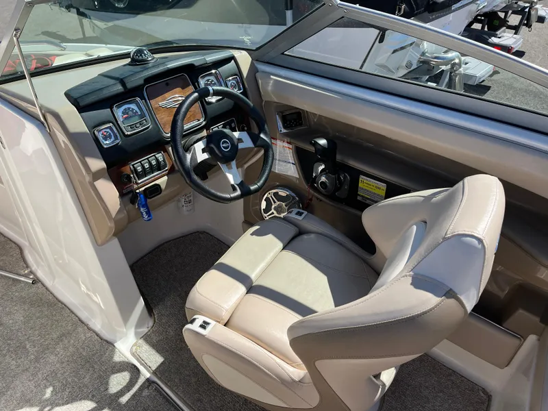 Slide: The Image of 2012 Chaparral 216 SSi boat cockpit with steering wheel and dashboard controls. - 11