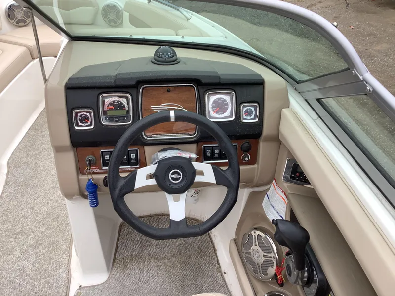 Slide: The Image of 2012 Chaparral 216 SSi boat dashboard with steering wheel and control panel. - 12