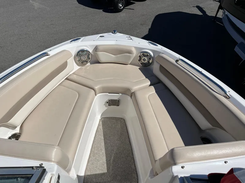 Slide: The Image of 2012 Chaparral 216 SSi boat interior with beige seating and speakers. - 13