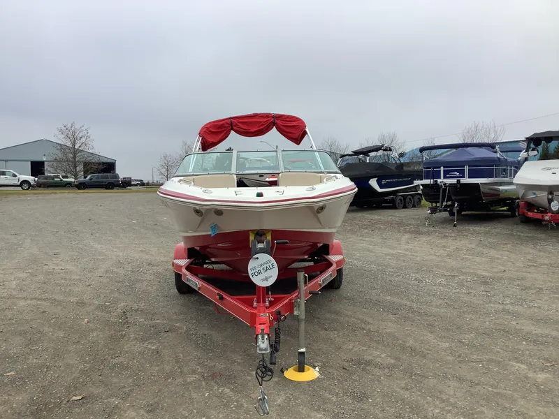 Slide: The Image of 2012 Chaparral 216 SSi boat on trailer, pre-owned, for sale in outdoor lot. - 3