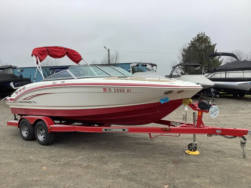 Slide: The Image of 2012 Chaparral 216 SSi boat on red trailer, for sale in outdoor lot. - 4