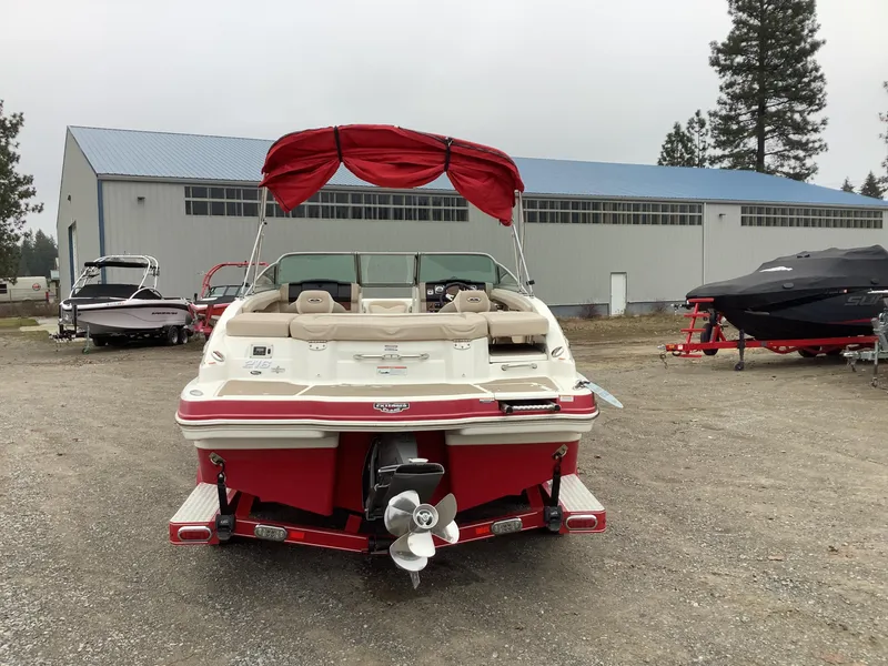 Slide: The Image of 2012 Chaparral 216 SSi boat with red canopy in outdoor storage area. - 7