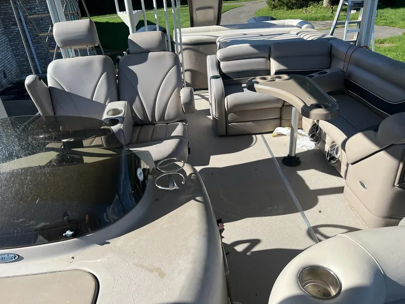 Slide: The Image of 2008 Premier 310 Boundary Waters pontoon boat interior with plush seating and cup holders. - 10