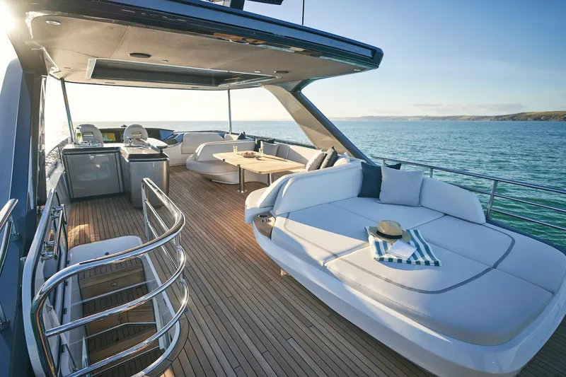 Slide: The Image of Luxurious 2025 Princess Y72 Motor Yacht deck with elegant seating and ocean view. - 10