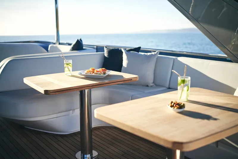 Slide: The Image of Luxurious 2025 Princess Y72 Motor Yacht deck with elegant dining setup and ocean view. - 15