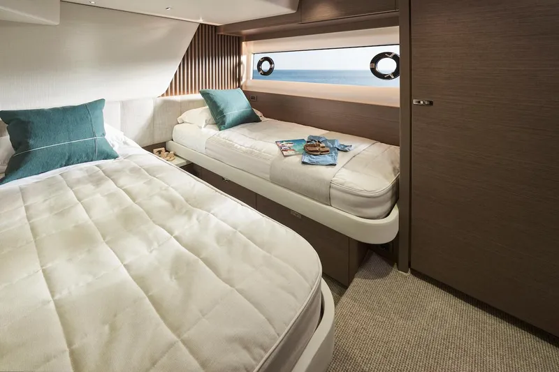 Slide: The Image of Luxurious cabin interior of 2025 Princess Y72 Motor Yacht with twin beds and ocean view. - 29